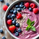 A bowl of. chia pudding with berries on a table