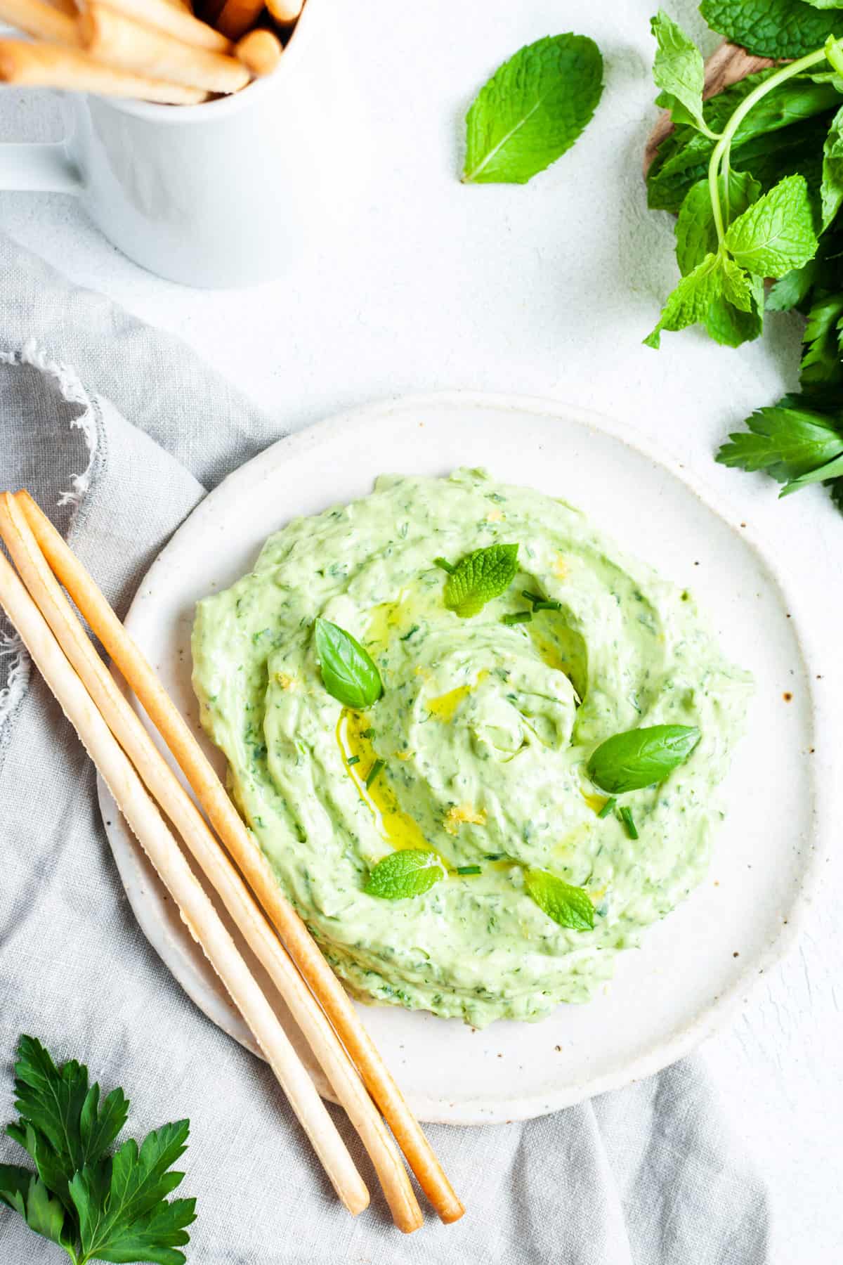 Green-goddess-dip Green goddess dip with grisini on a plate