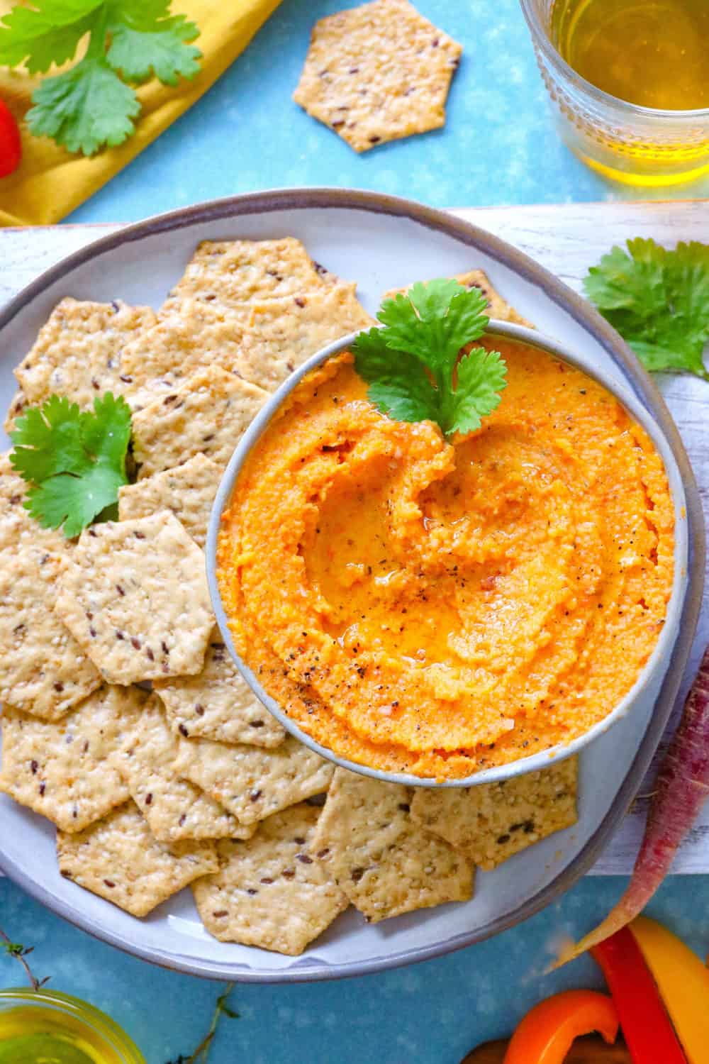 RoastedVegetableDip A bowl of troasted vegetable dip with crackers on a round plate