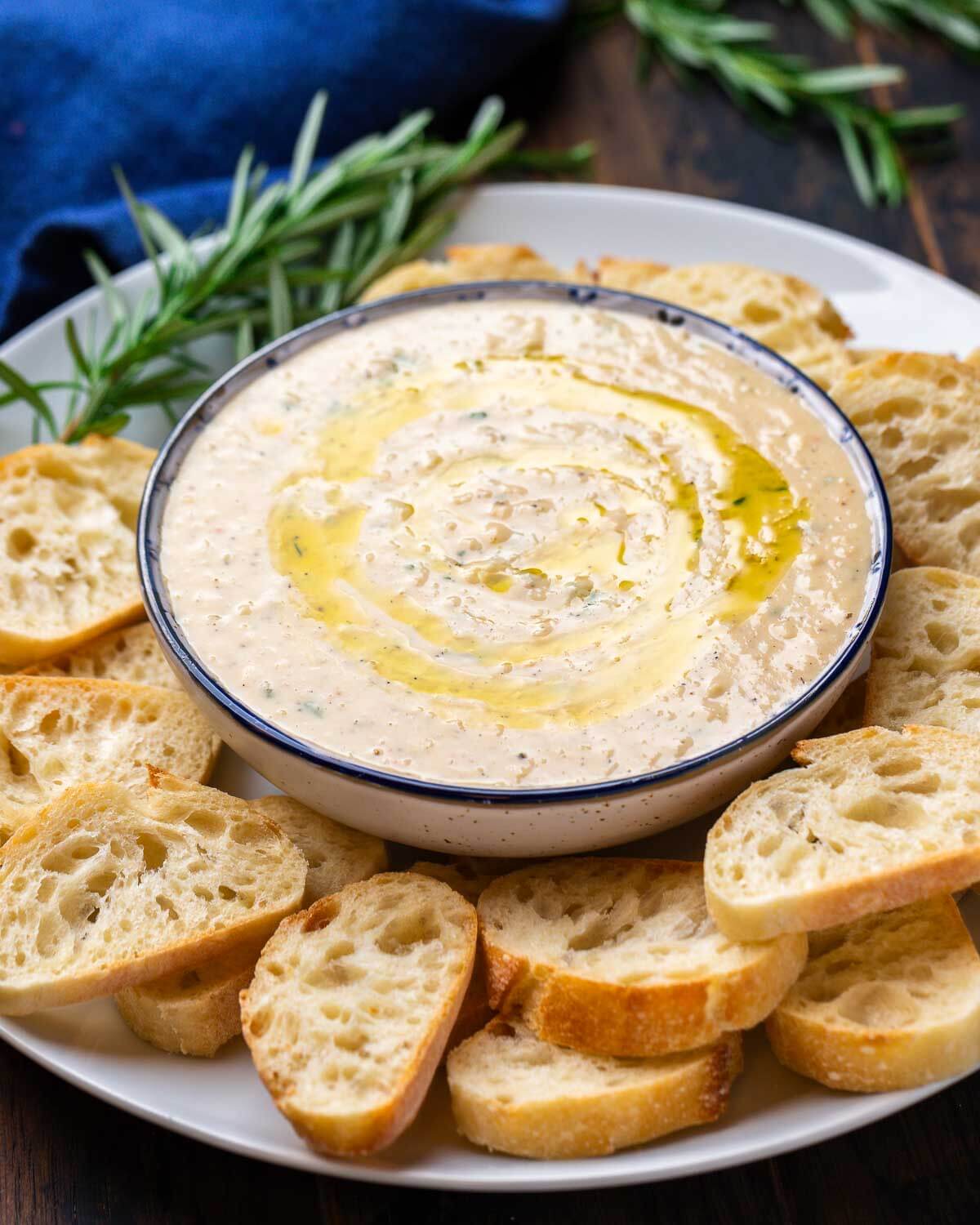 cannellini-bean-dip-recipe Cannellini bean dip with crostini on a plate