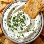 Bowl of greek yogurt dip and pita chips