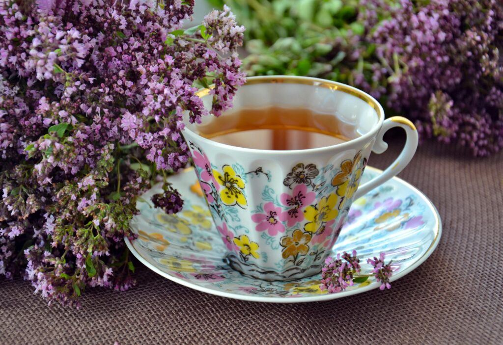 Cup of tea and a bunch of lilac flowers on a table